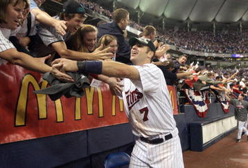 MINNEAPOLIS - OCTOBER 06:  Joe Mauer #7 of the Minnesota Twins celebrates with fans after winning the American League tiebreaker game against the Detroit Tigers on October 6, 2009 at Hubert H. Humphrey Metrodome in Minneapolis, Minnesota. (Photo by Jamie Squire/Getty Images)