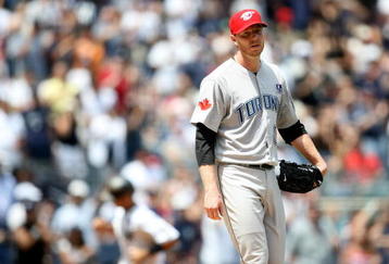 NEW YORK - JULY 04:  Roy Halladay #32 of the Toronto Blue Jays reacts after Jorge Posada #20 of the New York Yankees hit a home run in the fourth inning on July 4, 2009 at Yankee Stadium in the Bronx borough of New York City.  (Photo by Nick Laham/Getty Images)