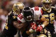 NEW ORLEANS - NOVEMBER 2:  Tony Gonzalez #88 of the Atlanta Falcons makes a first down then is stopped by Jonathan Vilma #51 and Darren Sharper #42 of the New Orleans Saints during the fourth quarter of the game at the Louisiana Superdome on November 2, 2009 in New Orleans, Louisiana. (Photo by Chris Graythen/Getty Images)