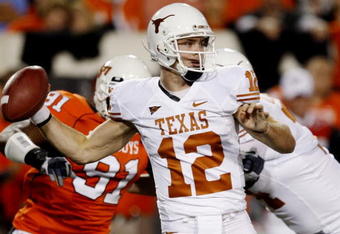 STILLWATER, OK - OCTOBER 31:  Quarterback Colt McCoy #12 of the Texas Longhorns goes back for a pass in the first quarter against the Oklahoma State Cowboys at Boone Pickens Stadium on October 31, 2009 in Stillwater, Oklahoma.  (Photo by Ronald Martinez/Getty Images)