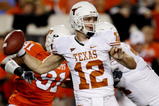 STILLWATER, OK - OCTOBER 31:  Quarterback Colt McCoy #12 of the Texas Longhorns goes back for a pass in the first quarter against the Oklahoma State Cowboys at Boone Pickens Stadium on October 31, 2009 in Stillwater, Oklahoma.  (Photo by Ronald Martinez/Getty Images)