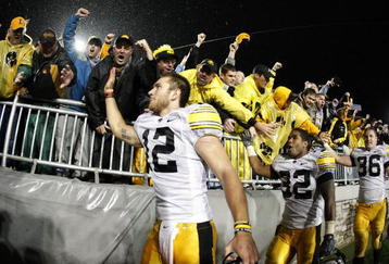 STATE COLLEGE, PA - SEPTEMBER 26:  Ricky Stanzi #12 of the Iowa Hawkeyes along with Adam Robinson #32 and Brett Morse #36 celebrate a 21-10 victory over the Penn State Nittnay Lions with Iowa fans on September 26, 2009 at Beaver Stadium in State College, Pennsylvania.  (Photo by Gregory Shamus/Getty Images)