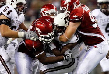 ARLINGTON, TX - OCTOBER 03:  Running back Christine Michael #33 of the Texas A&M Aggies is tackled by DeQuinta Jones #92 and Jake Bequette #91 of the Arkansas Razorbacks at Dallas Cowboys Stadium on October 3, 2009 in Arlington, Texas.  (Photo by Ronald Martinez/Getty Images)