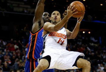CHARLOTTE, NC - DECEMBER 30:  D.J. Augustin #14 of the Charlotte Bobcats drives to the basket on Malik Rose #31 of the New York Knicks during their game at Time Warner Cable Arena on December 30, 2008 in Charlotte, North Carolina.  (Photo by Streeter Lecka/Getty Images)