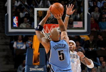 DENVER - OCTOBER 28:  Carlos Boozer #5 of the Utah Jazz takes a shot over Kenyon Martin #4 of the Denver Nuggets during NBA action at Pepsi Center on October 28, 2009 in Denver, Colorado. The Nuggets defeated the Jazz 114-105.  (Photo by Doug Pensinger/Getty Images)