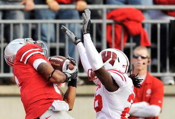 COLUMBUS, OH - OCTOBER 10:  DeVier Posey #8 of the Ohio State Buckeyes pulls in a 32-yard touchdown pass in front of Antonio Fenelus #26 of the Wisconsin Badgers at Ohio Stadium on October 10, 2009 in Columbus, Ohio.  (Photo by Jamie Sabau/Getty Images)