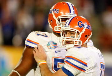 MIAMI - JANUARY 08:  Tim Tebow #15 (R) and Carl Johnson #57 of the Florida Gators celebrate after Tebow threw a 20-yard touchdown pass to Louis Murphy #9 in the second quarter against the Oklahoma Sooners during the FedEx BCS National Championship game at Dolphin Stadium on January 8, 2009 in Miami, Florida.  (Photo by Marc Serota/Getty Images)