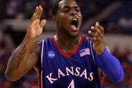 INDIANAPOLIS - MARCH 27:  Sherron Collins #4 of the Kansas Jayhawks reacts in the first half against the Michigan State Spartans during the third round of the NCAA Division I Men's Basketball Tournament at the Lucas Oil Stadium on March 27, 2009 in Indianapolis, Indiana.  (Photo by Andy Lyons/Getty Images)
