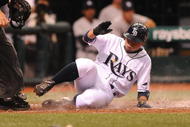 ST. PETERSBURG, FL - APRIL 15: Infielder Akinori Iwamura #1 of the Tampa Bay Rays slides into home plate for a run against the New York Yankees at Tropicana Field on April 15, 2009 in St. Petersburg, Florida.  (Photo by Al Messerschmidt/Getty Images)