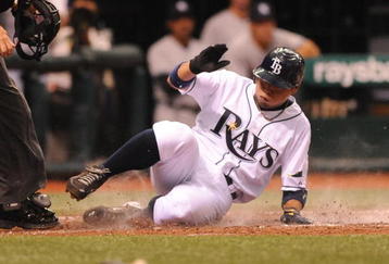 ST. PETERSBURG, FL - APRIL 15: Infielder Akinori Iwamura #1 of the Tampa Bay Rays slides into home plate for a run against the New York Yankees at Tropicana Field on April 15, 2009 in St. Petersburg, Florida.  (Photo by Al Messerschmidt/Getty Images)