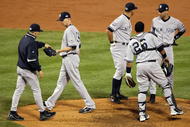 PHILADELPHIA - NOVEMBER 02: Manager Joe Girardi (R) of the New York Yankees takes starting pitcher A.J. Burnett #34 out of the game in the bottom of the third inning against the Philadelphia Phillies in Game Five of the 2009 MLB World Series at Citizens Bank Park on November 2, 2009 in Philadelphia, Pennsylvania. (Photo by Al Bello/Getty Images)