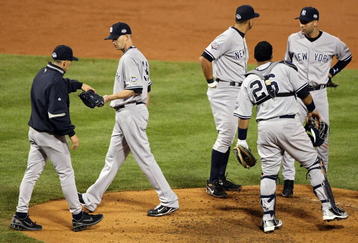 PHILADELPHIA - NOVEMBER 02:  Manager Joe Girardi (R) of the New York Yankees takes starting pitcher A.J. Burnett #34 out of the game in the bottom of the third inning against the Philadelphia Phillies in Game Five of the 2009 MLB World Series at Citizens Bank Park on November 2, 2009 in Philadelphia, Pennsylvania.  (Photo by Al Bello/Getty Images)