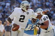 SAN DIEGO - NOVEMBER 01: JaMarcus Russell #2 of the Oakland Raiders scrambles out of the pocket as he is rushed by Larry Engllish #52 of the San Diego Chargers during the second quarter at Qualcomm Stadium on November 1, 2009 in San Diego California. (Photo by Harry How/Getty Images)