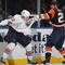 UNIONDALE, NY - NOVEMBER 02: Jean-Francois Jacques #22 of the Edmonton Oilers and Andy Sutton #25 of the New York Islanders square off at the Nassau Coliseum on November 2, 2009 in Uniondale, New York. (Photo by Bruce Bennett/Getty Images)