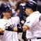 ST PETERSBURG, FL - OCTOBER 03:  Akinori Iwamura #1 of the Tampa Bay Rays is congratulated by Jason Bartlett #8 after Iwamura's two run home run in the fifth inning against the Chicago White Sox in Game 2 of the American Leaugue Divisional Series at Tropicana Field on October 3, 2008 in St. Petersburg, Florida.  (Photo by Doug Benc/Getty Images)
