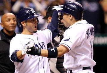 ST PETERSBURG, FL - OCTOBER 03:  Akinori Iwamura #1 of the Tampa Bay Rays is congratulated by Jason Bartlett #8 after Iwamura's two run home run in the fifth inning against the Chicago White Sox in Game 2 of the American Leaugue Divisional Series at Tropicana Field on October 3, 2008 in St. Petersburg, Florida.  (Photo by Doug Benc/Getty Images)