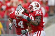 MADISON, WI - SEPTEMBER 26: O'Brien Schofield #50 of the Wisconsin Badgers celebrates with Chris Borland #44 against the Michigan State Spartans on September 26, 2009 at Camp Randall Stadium in Madison, Wisconsin. (Photo by Jonathan Daniel/Getty Images)