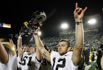 STATE COLLEGE, PA - SEPTEMBER 26:  Ricky Stanzi #12 of the Iowa Hawkeyes celebrates a 21-10 victory over the Penn State Nittnay Lions with Travis Meade #61 on September 26, 2009 at Beaver Stadium in State College, Pennsylvania.  (Photo by Gregory Shamus/Getty Images)