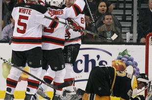 BOSTON - OCTOBER 29:  Dainius Zubrus #8 of the New Jersey Devils is congratulated after he scored the game winning goal by teammates Jamie Langenbrunner #15 and Colin White #5 as Derek Morris #53 of the Boston Bruins reacts on October 29, 2009 at the TD Garden in Boston, Massachusetts. The Devils defeated the Bruins 2-1.  (Photo by Elsa/Getty Images)