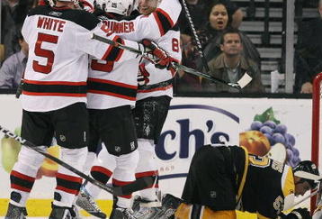 BOSTON - OCTOBER 29:  Dainius Zubrus #8 of the New Jersey Devils is congratulated after he scored the game winning goal by teammates Jamie Langenbrunner #15 and Colin White #5 as Derek Morris #53 of the Boston Bruins reacts on October 29, 2009 at the TD Garden in Boston, Massachusetts. The Devils defeated the Bruins 2-1.  (Photo by Elsa/Getty Images)