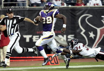 HOUSTON - AUGUST 31:  Running back Adrian Peterson #28 scores on a 75 yard run as strong safety Dominique Barber #34 of the Houston Texans makes a diving attempt to make the tackle at Reliant Stadium on August 31, 2009 in Houston, Texas.  (Photo by Bob Levey/Getty Images)