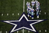 ARLINGTON, TX - NOVEMBER 01:  Quarterback Tony Romo #9 of the Dallas Cowboys huddles the offense during play against the Seattle Seahawks at Cowboys Stadium on November 1, 2009 in Arlington, Texas.  (Photo by Ronald Martinez/Getty Images)