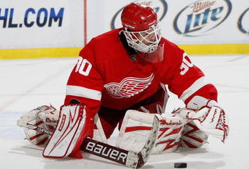 DETROIT - NOVEMBER 03:  Chris Osgood #30 of the of the Detroit Red Wings covers the puck after stopping a shot while playing the Boston Bruins on November 3, 2009 at Joe Louis Arena in Detroit, Michigan. Detroit won the game 2-0.  (Photo by Gregory Shamus/Getty Images)