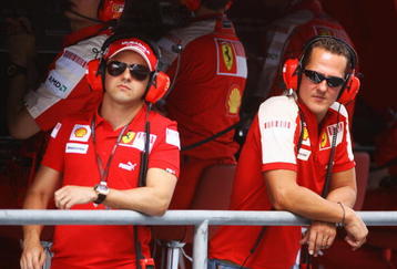 ABU DHABI, UNITED ARAB EMIRATES - OCTOBER 30:  Former Ferrari F1 World Champion Michael Schmumacher (R) of Germany talks with Felipe Massa (L) of Brazil and Ferrari on the pitwall during practice for the Abu Dhabi Formula One Grand Prix at the Yas Marina Circuit on October 30, 2009 in Abu Dhabi, United Arab Emirates.  (Photo by Paul Gilham/Getty Images)
