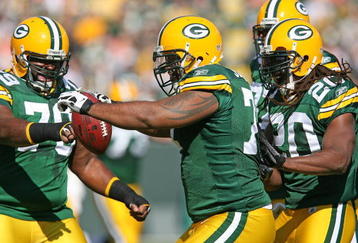 GREEN BAY, WI - OCTOBER 18: Cullen Jenkins #77 of the Green Bay Packers celebrates with teammates Ryan Pickett #79 and Atari Bigby #20 after intercepting a pass at Lambeau Field on October 18, 2009 in Green Bay, Wisconsin. The Packers defeated the Lions 26-0. (Photo by Jonathan Daniel/Getty Images)