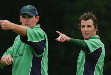 BELFAST, UNITED KINGDOM - JUNE 24:  Trent Johnstone (L) and Kyle McCallan of Ireland make an adjustment to the field during the One Day International match between Ireland and South Africa at the Civil Service Cricket Club in Stormont on June 24, 2007 in Belfast, Northern Ireland.  (Photo by Hamish Blair/Getty Images)