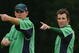BELFAST, UNITED KINGDOM - JUNE 24:  Trent Johnstone (L) and Kyle McCallan of Ireland make an adjustment to the field during the One Day International match between Ireland and South Africa at the Civil Service Cricket Club in Stormont on June 24, 2007 in Belfast, Northern Ireland.  (Photo by Hamish Blair/Getty Images)