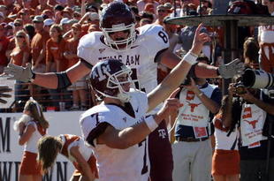 AUSTIN, TX - NOVEMBER 24: Quarterback Stephen McGee #7 of the Texas A&M Aggies celebrates his touchdown with Joey Thomas #81 during a game against the Texas Longhorns at Darrell K Royal-Texas Memorial Stadium November 24, 2006 in Austin, Texas. The Aggies defeated the Longhorns 12-7. (Photo by Ronald Martinez/Getty Images)