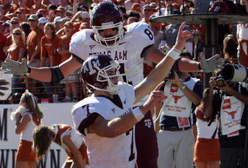 AUSTIN, TX - NOVEMBER 24:  Quarterback Stephen McGee #7 of the Texas A&M Aggies celebrates his touchdown with Joey Thomas #81 during a game against the Texas Longhorns at Darrell K Royal-Texas Memorial Stadium November 24, 2006 in Austin, Texas. The Aggies defeated the Longhorns 12-7.  (Photo by Ronald Martinez/Getty Images)