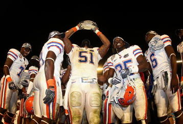 MIAMI - JANUARY 08:  Brandon Spikes #51 of the Florida Gators celebrate with the trophy after defeating the Oklahoma Sooners in the FedEx BCS National Championship Game at Dolphin Stadium on January 8, 2009 in Miami, Florida. The Gators won the game by a score of 24-14.  (Photo by Donald Miralle/Getty Images)