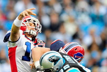 CHARLOTTE, NC - OCTOBER 25:  Ryan Fitzpatrick #14 of the Buffalo Bills throws under pressure from Gary Barnidge #82 of the Carolina Panthers  during the first quarter at Bank of America Stadium on October 25, 2009 in Charlotte, North Carolina.  (Photo by Grant Halverson/Getty Images)