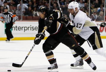 ANAHEIM, CA - NOVEMBER 03:  Teemu Selanne #8 of the Anaheim Ducks is pursued by Michael Rupp #17 of the Pittsburgh Penguins in the third period at the Honda Center on November 3, 2009 in Anaheim, California. The Penguins defeated the Ducks 4-3.  (Photo by Jeff Gross/Getty Images)