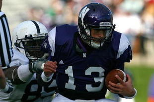 EVANSTON, IL - OCTOBER 31: Mike Kafka #13 of the Northwestern Wildcats is pulled down by Ollie Ogbu #85 of the Penn State Nittany Lions as teammate Josh Hull #43 collides with a referee at Ryan Field on October 31, 2009 in Evanston, Illinois. Penn State defeated Northwestern 34-13. (Photo by Jonathan Daniel/Getty Images)