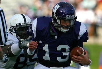 EVANSTON, IL - OCTOBER 31: Mike Kafka #13 of the Northwestern Wildcats is pulled down by Ollie Ogbu #85 of the Penn State Nittany Lions as teammate Josh Hull #43 collides with a referee at Ryan Field on October 31, 2009 in Evanston, Illinois. Penn State defeated Northwestern 34-13. (Photo by Jonathan Daniel/Getty Images)