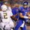 BOISE, ID - SEPTEMBER 3:  Kellen Moore #11 of the Boise State throws a pass under pressure by T.J. Ward #2 of the Oregon Ducks in second quarter of the game on September 3, 2009 at Broncos Stadium in Boise, Idaho. Boise State won the game 19-8. (Photo by Steve Dykes/Getty Images)