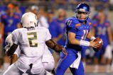 BOISE, ID - SEPTEMBER 3:  Kellen Moore #11 of the Boise State throws a pass under pressure by T.J. Ward #2 of the Oregon Ducks in second quarter of the game on September 3, 2009 at Broncos Stadium in Boise, Idaho. Boise State won the game 19-8. (Photo by Steve Dykes/Getty Images)
