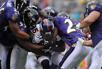 BALTIMORE - NOVEMBER 1:  Brandon Marshall #15 of the Denver Broncos is tackled by the Baltimore Ravens defense at M&T Bank Stadium on November 1, 2009 in Baltimore, Maryland. The Ravens defeated the Broncos 30-7. (Photo by Larry French/Getty Images)