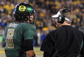EUGENE, OR - OCTOBER 31: Quarterback Jeremiah Masoli #8 and speaks with head coach Chip Kelly of the Oregon Ducks during a timeout in the third quarter of the game against the USC Trojans at Autzen Stadium on October 31, 2009 in Eugene, Oregon. Masoli threw for 222 yards and a touchdown and ran for 164 more yards with another score as Oregon defeated USC 47-20. (Photo by Steve Dykes/Getty Images)