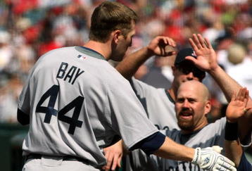 ANAHEIM, CA - APRIL 11: Jason Bay #44 of the Boston Red Sox is greeted by Kevin Youkilis #20 and other teammates as he returns to the dugout after hitting a two run home run in the seventh inning against the Los Angeles Angels of Anaheim on April 11, 2009 at Angel Stadium in Anaheim, California. The Red Sox won 5-4.  (Photo by Stephen Dunn/Getty Images)