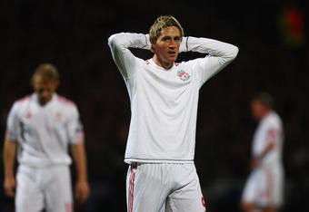 LYON, FRANCE - NOVEMBER 04:  Fernando Torres holds his head after a missed chance during the UEFA Champions League Group E match between Lyon and Liverpool at the Stade de Gerland on November 4, 2009 in Lyon, France.  (Photo by Michael Steele/Getty Images)