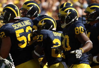 ANN ARBOR, MI - SEPTEMBER 19:  Michigan Wolverines  offensive players huddle by the sideline before taking the field for a series against the Eastern Michigan Eagles at Michigan Stadium on September 19, 2009 in Ann Arbor, Michigan.  Michigan won 45-17.  (Photo by Stephen Dunn/Getty Images)