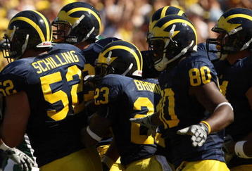 ANN ARBOR, MI - SEPTEMBER 19:  Michigan Wolverines  offensive players huddle by the sideline before taking the field for a series against the Eastern Michigan Eagles at Michigan Stadium on September 19, 2009 in Ann Arbor, Michigan.  Michigan won 45-17.  (Photo by Stephen Dunn/Getty Images)