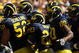 ANN ARBOR, MI - SEPTEMBER 19:  Michigan Wolverines  offensive players huddle by the sideline before taking the field for a series against the Eastern Michigan Eagles at Michigan Stadium on September 19, 2009 in Ann Arbor, Michigan.  Michigan won 45-17.  (Photo by Stephen Dunn/Getty Images)