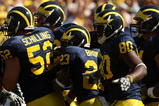 ANN ARBOR, MI - SEPTEMBER 19:  Michigan Wolverines  offensive players huddle by the sideline before taking the field for a series against the Eastern Michigan Eagles at Michigan Stadium on September 19, 2009 in Ann Arbor, Michigan.  Michigan won 45-17.  (Photo by Stephen Dunn/Getty Images)