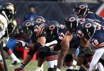 CHICAGO - DECEMBER 07: Orlin Kreutz #57 of the Chicago Bears prepares to snap the ball as teammates Josh Beekman #67, John St. Clair #78 and Desmond Clark #88 await the start of a play against the Jacksonville Jaguars on December 7, 2008 at Soldier Field in Chicago, Illinois. The Bears defeated the Jaguars 23-10. (Photo by Jonathan Daniel/Getty Images)