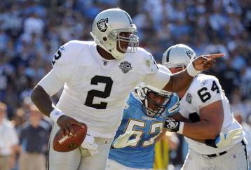 SAN DIEGO - NOVEMBER 01:  JaMarcus Russell #2 of the Oakland Raiders scrambles out of the pocket as he is rushed by Larry Engllish #52 of the San Diego Chargers during the second quarter at Qualcomm Stadium on November 1, 2009 in San Diego California.  (Photo by Harry How/Getty Images)